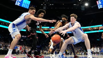 Mar 15, 2025; Charlotte, NC, USA; Duke Blue Devils forward Mason Gillis (18) and guard Kon Knueppel (7) and Louisville Cardinals guard Chucky Hepburn (24) and forward James Scott (0) reach for the ball in the second half during the 2025 ACC Conference Championship game at Spectrum Center. Mandatory Credit: Bob Donnan-Imagn Images