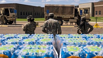 JACKSON, MS - SEPTEMBER 01: Members of the Mississippi National Guard hand out bottled water at Thomas Cardozo Middle School in response to the water crisis on September 01, 2022 in Jackson, Mississippi. Jackson has been experiencing days without reliable water service after river flooding caused the main treatment facility to fail. (Photo by Brad Vest/Getty Images)