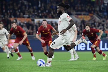 (FILES) In this file photo taken on October 31, 2021 AC Milan's Ivorian midfielder Franck Kessie shoots to score a penalty during the Italian Serie A football match between AS Roma and AC Milan on October 31, 2021 at the Olympic stadium in Rome. - In Ital