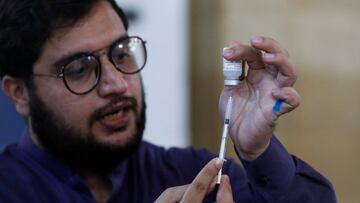 A healthcare worker prepares a dose of Moderna coronavirus disease  vaccine at a vaccination centre in Karachi, Pakistan.