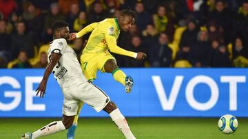 Nantes&#039; Nigerian forward Moses Simon (R) shoots the ball during the French L1 football match between Nantes (FCN) and Dijon (DFCO) at the Beaujoire stadium in Nantes, on December 8, 2019. (Photo by LOIC VENANCE / AFP)