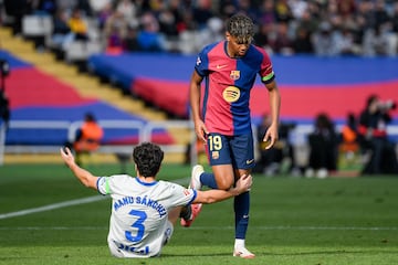 Barcelona's Spanish forward #19 Lamine Yamal (R) steps over Alaves' Spanish defender #03 Manuel Sanchez during the Spanish league football match between FC Barcelona and Deportivo Alaves at the Estadi Olimpic Lluis Companys in Barcelona on February 2, 2025. (Photo by Josep LAGO / AFP)