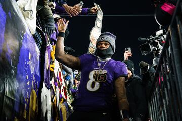 Lamar Jackson high celebrates with fans after beating the Houston Texans.