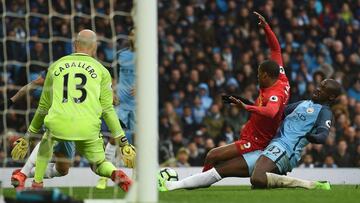 Manchester City's Ivorian midfielder Yaya Toure (R) tackles Liverpool's Dutch midfielder Georginio Wijnaldum during the English Premier League football match between Manchester City and Liverpool at the Etihad Stadium in Manchester, north west England, on March 19, 2017. / AFP PHOTO / PAUL ELLIS / RESTRICTED TO EDITORIAL USE. No use with unauthorized audio, video, data, fixture lists, club/league logos or 'live' services. Online in-match use limited to 75 images, no video emulation. No use in betting, games or single club/league/player publications. /