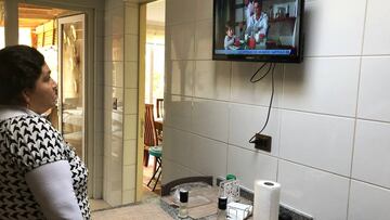 A woman watches a soap opera in Santiago on April 14, 2020, amid the new coronavirus pandemic. - Without kisses, hugs or proximity among actors for the fear of contracting coronavirus, soap operas remain in pause in Latin Alerica, forcing the industry to redefine its future in the social isolation era. (Photo by PAULINA ABRAMOVICH / AFP)