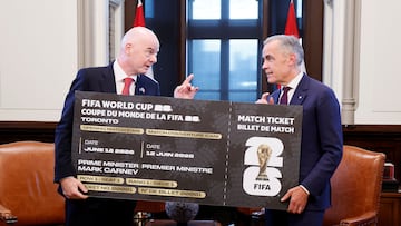 Canada's Prime Minister Mark Carney and FIFA’s President Gianni Infantino hold a novelty ticket to a World Cup match on Parliament Hill in Ottawa, Ontario, Canada October 10, 2025. REUTERS/Blair Gable