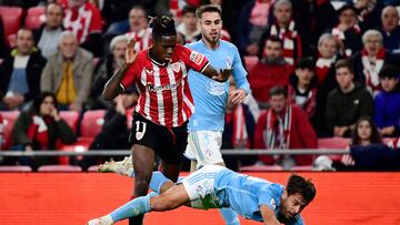 Athletic Bilbao's Spanish forward #11 Nico Williams vies with Celta Vigo's Spanish defender #20 Kevin Vazquez (BOTTOM) during the Spanish league football match between Athletic Club Bilbao and RC Celta de Vigo at the San Mames stadium in Bilbao on November 10, 2023. (Photo by ANDER GILLENEA / AFP)