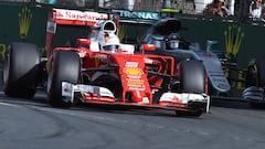 Sebastian Vettel con el Ferrari por delante de Nico Rosberg y su Mercedes.