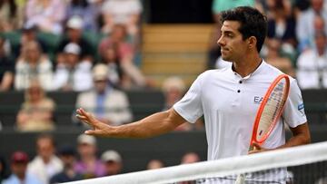 Chile's Cristian Garin reacts as he plays against Australia's Nick Kyrgios during their men's singles quarter final tennis match on the tenth day of the 2022 Wimbledon Championships at The All England Tennis Club in Wimbledon, southwest London, on July 6, 2022. - RESTRICTED TO EDITORIAL USE (Photo by SEBASTIEN BOZON / AFP) / RESTRICTED TO EDITORIAL USE (Photo by SEBASTIEN BOZON/AFP via Getty Images)