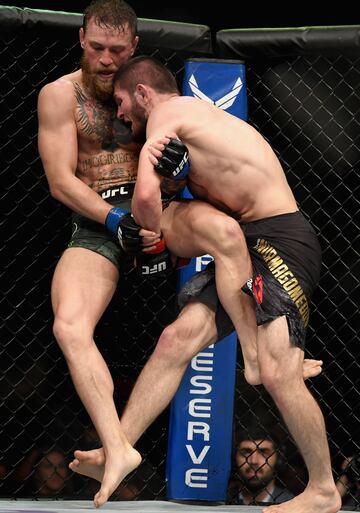 LAS VEGAS, NV - OCTOBER 06: Khabib Nurmagomedov of Russia (R) pins Conor McGregor of Ireland in the corner in their UFC lightweight championship bout during the UFC 229 event inside T-Mobile Arena on October 6, 2018 in Las Vegas, Nevada.   Harry How/Getty