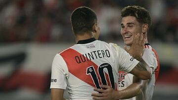 River Plate's Colombian midfielder Juan Quintero (L) celebrates with teammate forward Julian Alvarez after scoring the team's fourth goal by penalty kick against Patronato during their Argentine Professional Football League match at the Monumental stadium in Buenos Aires, Argentina, on February 16, 2022. (Photo by JUAN MABROMATA / AFP)