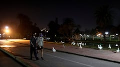 Men wearing protective face masks walk at a park, as the city of Buenos Aires eases their lockdown restrictions, during the spread of the coronavirus disease (COVID-19), in Buenos Aires, Argentina June 8, 2020. REUTERS/Agustin Marcarian