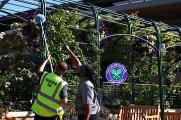 Los trabajadores del torneo ultiman la limpieza de las instalaciones del All England Lawn Tennis and Croquet Club. 