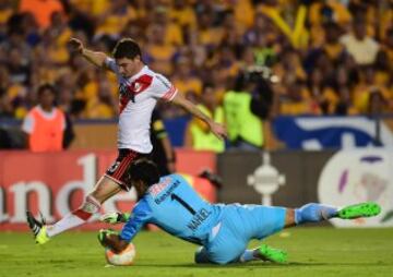 Goalie Nahuel Guzman (bottom) of Mexico's Tigres vies for the ball with Lucas Alario, of Argentina's River Plate, during their Libertadores Cup first leg final, at the Universitario Stadium, in Monterrey, Nuevo Leon State, Mexico, on July 29, 2015. AFP PHOTO/RONALDO SCHEMIDT