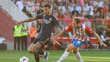 Real Madrid's Spanish forward #14 Joselu (L) fights for the ball with Girona's Dutch defender #17 Daley Blind during the Spanish Liga football match between Girona FC and Real Madrid CF at the Montilivi stadium in Girona on September 30, 2023. (Photo by Josep LAGO / AFP)