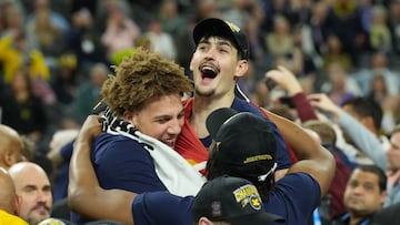 Michigan Wolverines center Aday Mara (15) celebrates with teammates after defeating the Connecticut Huskies in the national championship of the Final Four of the men's 2026 NCAA Tournament at Lucas Oil Stadium.