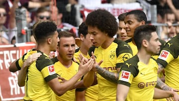 Dortmund's English midfielder Jadon Sancho is congratulated by teammates German midfielder Mario Goetze (2ndL) and Belgian midfielder Axel Witsel (3rdR) after he scored the first goal during the German first division Bundesliga football match SC Frei