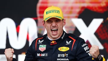 TOPSHOT - Red Bull Racing's Dutch driver Max Verstappen celebrates at the podium of the Formula One Sao Paulo Grand Prix, at the Jose Carlos Pace racetrack, aka Interlagos, in Sao Paulo, Brazil, on November 3, 2024. (Photo by Miguel Schincariol / AFP)