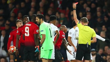 MANCHESTER, ENGLAND - FEBRUARY 12: Referee Daniele Orsato shows a red card to Paul Pogba of Manchester United during the UEFA Champions League Round of 16 First Leg match between Manchester United and Paris Saint-Germain at Old Trafford on February 12, 2