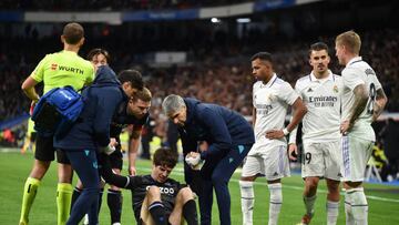 MADRID, SPAIN - JANUARY 29: Aritz Elustondo of Real Sociedad is helped to their feet after receiving medical treatment during the LaLiga Santander match between Real Madrid CF and Real Sociedad at Estadio Santiago Bernabeu on January 29, 2023 in Madrid, Spain. (Photo by Denis Doyle/Getty Images)