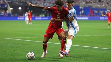 Canada's forward #17 Tajon Buchanan (L) fights for the ball with Argentina's defender #25 Lisandro Martinez during the Conmebol 2024 Copa America tournament group A football match between Argentina and Canada at Mercedes Benz Stadium in Atlanta, Georgia, on June 20, 2024. (Photo by CHARLY TRIBALLEAU / AFP)