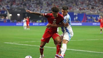 Canada's forward #17 Tajon Buchanan (L) fights for the ball with Argentina's defender #25 Lisandro Martinez during the Conmebol 2024 Copa America tournament group A football match between Argentina and Canada at Mercedes Benz Stadium in Atlanta, Georgia, on June 20, 2024. (Photo by CHARLY TRIBALLEAU / AFP)