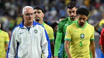 Brazil's coach Dorival Junior (L) and Brazil's defender #04 Marquinhos react after their team's defeat in the Conmebol 2024 Copa America tournament quarter-final football match between Uruguay and Brazil at Allegiant Stadium in Las Vegas, Nevada on July 6, 2024. (Photo by Robyn BECK / AFP)