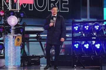 Seacrest walks onstage in Times Square during New Year's Eve celebrations.