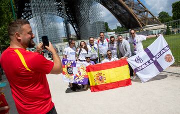 Real Madrid fans pose for photographs by the Eiffel Tower ahead of the Champions League final in Paris.
