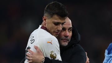 Manchester City's Spanish manager Pep Guardiola (C) congratulates Manchester City's Spanish midfielder #16 Rodri (L) on the pitch after the English Premier League football match between Bournemouth and Manchester City at the Vitality Stadium in Bournemouth, southern England on February 24, 2024. Manchester City won the game 1-0. (Photo by Adrian DENNIS / AFP) / RESTRICTED TO EDITORIAL USE. No use with unauthorized audio, video, data, fixture lists, club/league logos or 'live' services. Online in-match use limited to 120 images. An additional 40 images may be used in extra time. No video emulation. Social media in-match use limited to 120 images. An additional 40 images may be used in extra time. No use in betting publications, games or single club/league/player publications. / 