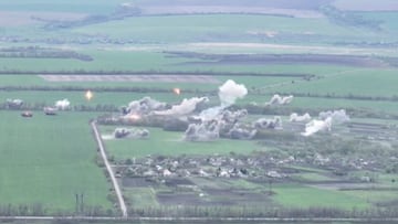 Explosions are seen in a village during a military strike in a location given as near Izium, Ukraine in this screen grab obtained from a social media video released April 30, 2022. Courtesy of National Guard Of Ukraine/via REUTERS  THIS IMAGE HAS BEEN SUP