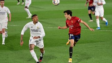 Real Madrid's Brazilian defender Eder Militao (L) and osasunaxB4s Spanush midfielder Manuel Sanchez eye the ball during the Spanish League football match between Real Madrid and Osasuna at the Alfredo Di Stefano stadium in Valdebebas in the outskirts of M
