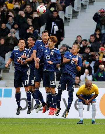 Soccer Football - International Friendly - Brazil vs Japan - Stade Pierre-Mauroy, Lille, France - November 10, 2017   Japan's defensive wall jump up to block a free kick as Brazil’s Fernandinho ducks 