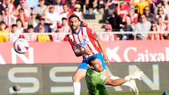Girona's Spanish midfielder #23 Ivan Martin scores his team's first goal in spite of Almeria's Spanish goalkeeper #13 Fernando Martinez during the Spanish league football match between Girona FC and UD Almeria at the Montilivi stadium in Girona on October 22, 2023. (Photo by Pau BARRENA / AFP)