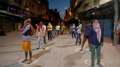 People stand apart in a line to receive free food being distributed on a street during a 21-day nationwide lockdown to limit the spreading of coronavirus disease (COVID-19), in New Delhi, India March 30, 2020. REUTERS/Anushree Fadnavis