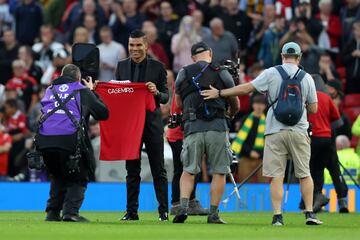 MANCHESTER, ENGLAND - AUGUST 22: New signing, Casemiro of Manchester United poses for a photo with a shirt as they are introduced to fans prior to the Premier League match between Manchester United and Liverpool FC at Old Trafford on August 22, 2022 in Manchester, England. (Photo by Clive Brunskill/Getty Images)