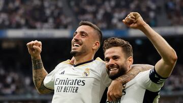 Real Madrid's Spanish forward #14 Joselu (L) celebrates scoring his team's third goal, with Real Madrid's Spanish defender #06 Nacho Fernandez, during the Spanish league football match between Real Madrid CF and Cadiz CF at the Santiago Bernabeu stadium in Madrid on May 4, 2024. (Photo by OSCAR DEL POZO / AFP)