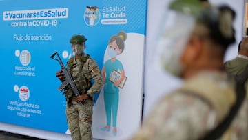 Army soldiers stand guard at a major vaccination centre in Lima where hundreds of Peruvian health workers receive their first dose against COVID-19 in Lima, on February 9, 2021. - Peru began its coronavirus immunisation program just two days after receiving 300,000 vaccine doses from state-owned Chinese company Sinopharm. Health care workers in Lima were the first to receive the vaccine on Tuesday morning. At least 298 doctors and 25 nurses have died in Peru due to the COVID-19 pandemic, among more than 20,000 health professionals who have contracted the virus, according to trade union organisations. (Photo by Luka GONZALES / AFP)