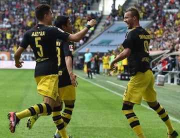 Dortmund's Spanish defender Marc Bartra, Japanese midfielder Shinji Kagawa and Ukrainian forward Andrey Yarmolenko celebrate.