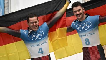 Germany&#039;s Christopher Grotheer and Axel Jungk pose for pictures after the men&#039;s skeleton gold medal event at the Yanqing National Sliding Centre during the Beijing 2022 Winter Olympic Games in Yanqing on February 11, 2022. 