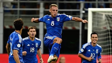 Italy's midfielder #08 Davide Frattesi (C) jumps in the air in celebration after scoring Italy's first goal during the Euro 2024 football tournament Group C qualifying match between Italy and Ukraine, at Stadio San Siro in Milan, on September 12, 2023. (Photo by GABRIEL BOUYS / AFP)