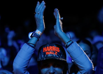 A supporter wearing a "Harris Walz" cap 