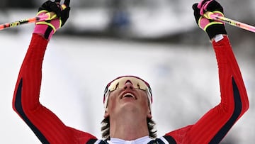 Norway's Johannes Hoesflot Klaebo celebrates as he crosses the finish line to win gold in the men's cross country 50km mass start final event of the Milano Cortina 2026 Winter Olympic Games at Tesero Cross-Country Skiing Stadium in Lago di Tesero (Val di Fiemme) on February 21, 2026. (Photo by Javier SORIANO / AFP)