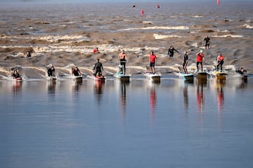 Un grupo de personas monta una ola de macareo en tablas de surf y de remo en Saint-Pardon en el río Dordoña, al suroeste de Francia. Un macareo? es un fenómeno en el que el frente de la marea ascendente forma una ola que remonta un río o bahía estrecha contra la dirección del caudal. Acontece durante las mareas más vivas.