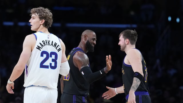 Nov 18, 2025; Los Angeles, California, USA; Los Angeles Lakers forward LeBron James (center) and guard Luka Doncic (77) react as Utah Jazz forward Lauri Markkanen (23) watches in the fourth quarter at Crypto.com Arena. Mandatory Credit: Kirby Lee-Imagn Images