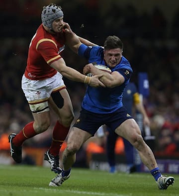 Wales' centre Jonathan Davies tackles France's hooker Camille Chat during the Six Nations challenge.