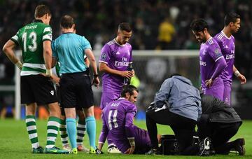 Real Madrid's Welsh forward Gareth Bale (DOWN) is checked by medics during the UEFA Champions League football match Sporting CP vs Real Madrid CF