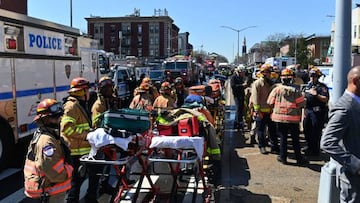 A man in a construction vest, grey hoodie and gas mask has attacked and shot at least 10 people at a subway station in NYC.