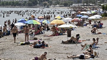 ALIMOS, GREECE - MAY 16:Beachgoers enjoy the sun and sea at public beach during the official reopening of beaches to the public on May 16, 2020 in Varkiza, Greece. Greece allowed the reopening of organised beaches after easing of measures against the spread of the coronavirus disease (COVID-19)with strict social distancing measures that would affect private beaches all over Greece, where shade umbrellas must be planted at least 4 meters (13 feet) apart, and a maximum 40 Beachgoers will be allowed in every 1,000 square meters (11,000 square feet) of beach. (Photo by Milos Bicanski/Getty Images)