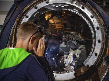 Un niño observa el interior de una cápsula espacial